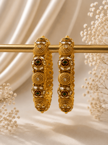 Pair of gold-tone heritage bangles with green stone inlays and circular motifs