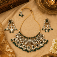 Bridal kundan necklace with emerald green stones and pearl bead fringe; matching earrings