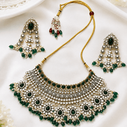 Kundan bridal necklace and matching earrings with emerald green stones and pearl beadwork