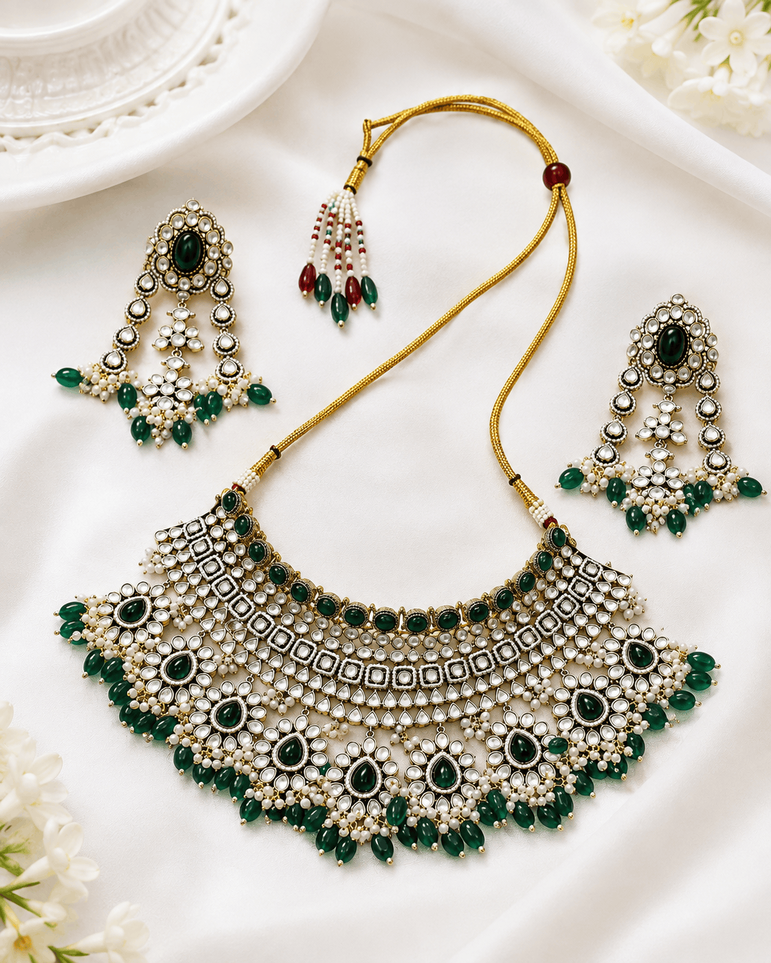 Kundan bridal necklace and matching earrings with emerald green stones and pearl beadwork