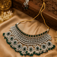 Bridal kundan necklace set with emerald green stones and pearl fringe; matching earrings