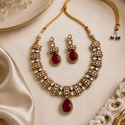 Gold-tone heritage necklace set with red teardrop pendant and matching beadwork earrings