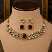 Gold-tone choker necklace with ruby-pink square stones and matching stud drop earrings, front view.