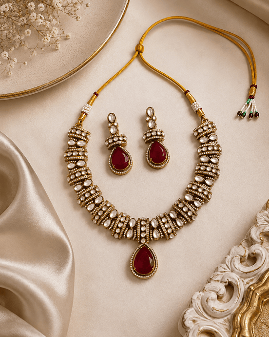 Gold-tone heritage necklace set with red teardrop pendant and matching beadwork earrings