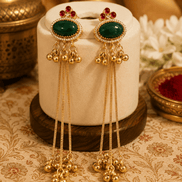 Gold tassel earrings with oval green stones, red accents, and dangling beaded charms