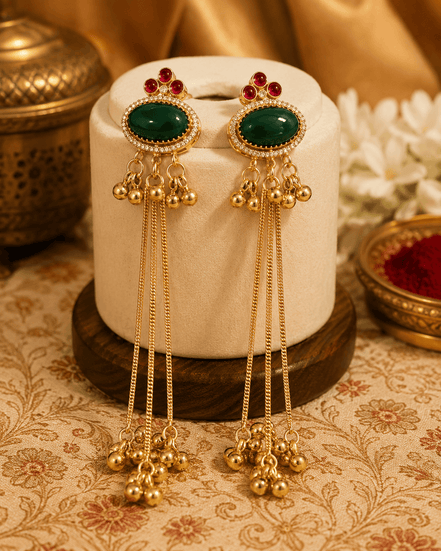 Gold tassel earrings with oval green stones, red accents, and dangling beaded charms