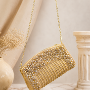 Gold-tone crystal minaudiere-style clutch bag with short chain strap and rounded top