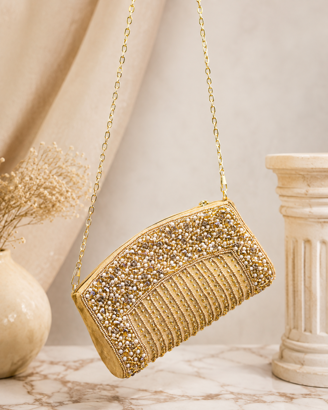 Gold-tone crystal minaudiere-style clutch bag with short chain strap and rounded top