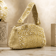 Gold-tone beaded crystal top handle bag with pearl-like bead detailing and chain strap