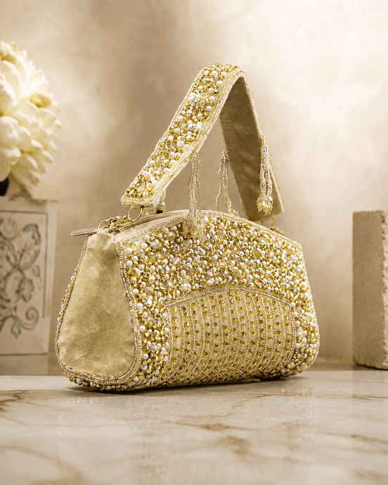 Gold-tone beaded crystal top handle bag with pearl-like bead detailing and chain strap