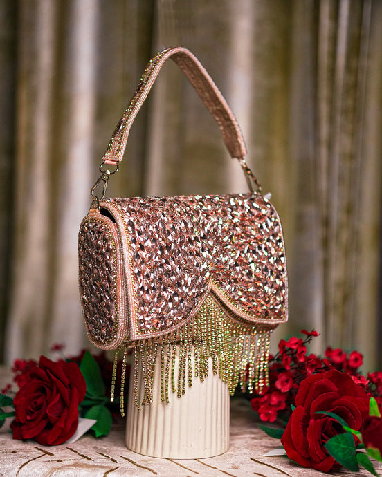 Rose gold beaded crystal shoulder bag with arched flap detail and long hanging fringe