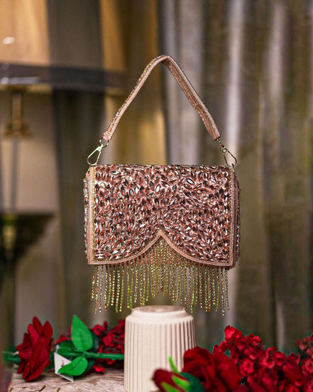 Rose gold crystal fringe handbag with top handle, embellished front flap and beaded drops