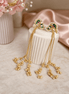 Gold-tone tassel earrings with ruby-pink and teal cabochon drops and chain fringes