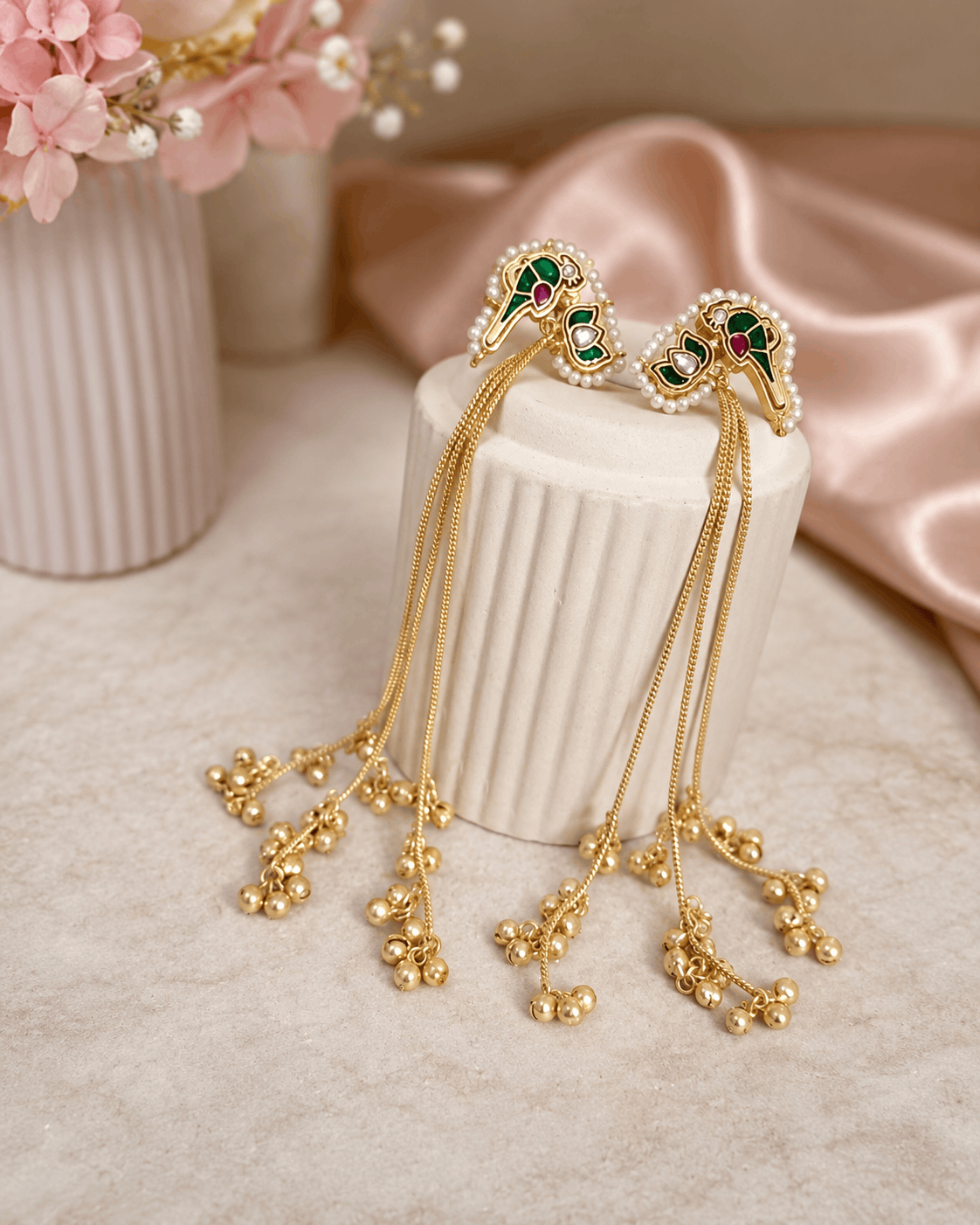 Gold-tone tassel earrings with ruby-pink and teal cabochon drops and chain fringes