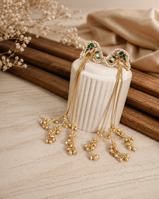 Gold-tone tassel earrings with ruby-pink and teal cabochon center and dangling bead fringe