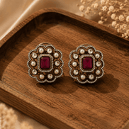 Royal Heritage pearl stud earrings with ruby-red center, round scalloped frame and studs
