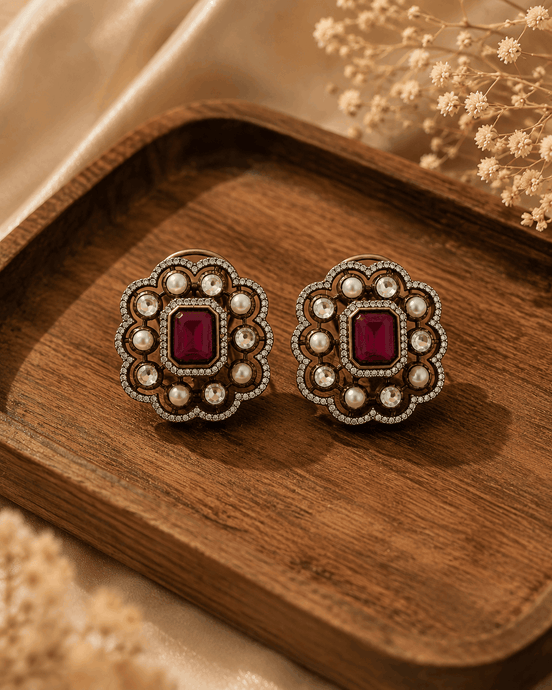 Royal Heritage pearl stud earrings with ruby-red center, round scalloped frame and studs