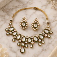 Gold kundan choker necklace set with green teardrop stones and stud earrings