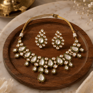 Gold kundan necklace and earrings set with oval and teardrop green stones