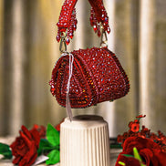 Red crystal mini bag with arched top handle, beaded fringes, and rounded flap