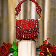 Red crystal mini bag with curved beaded handles and scalloped flap detail