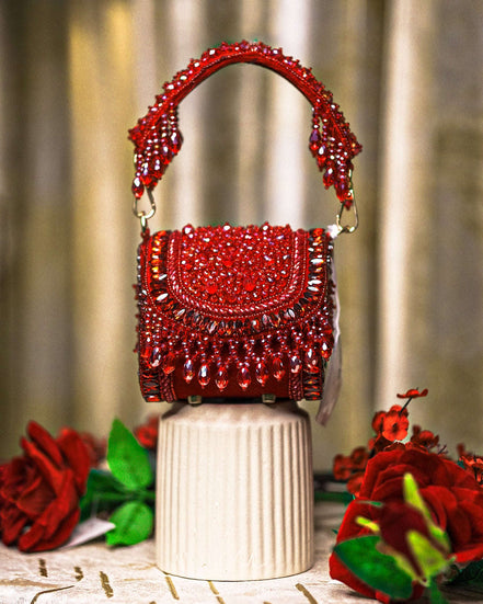 Red crystal mini bag with curved beaded handles and scalloped flap detail