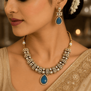 Gold-tone heritage necklace set with blue teardrop pendant and matching dangle earrings