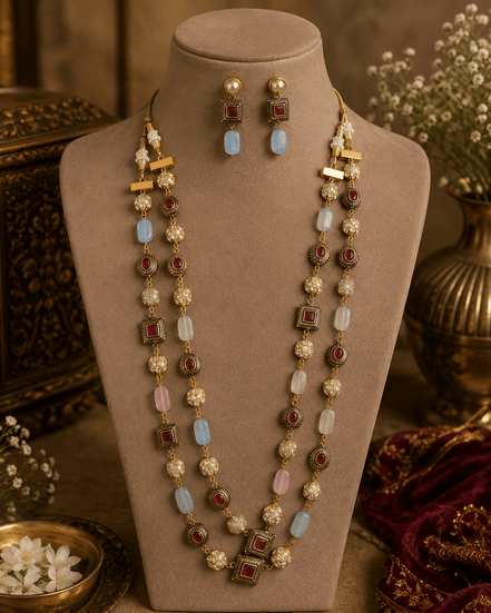 Gold-tone mala necklace with pink, light-blue, and red beads plus matching drop earrings on bust