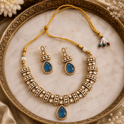 Gold-tone heritage necklace set with blue teardrop pendant and beadwork earrings