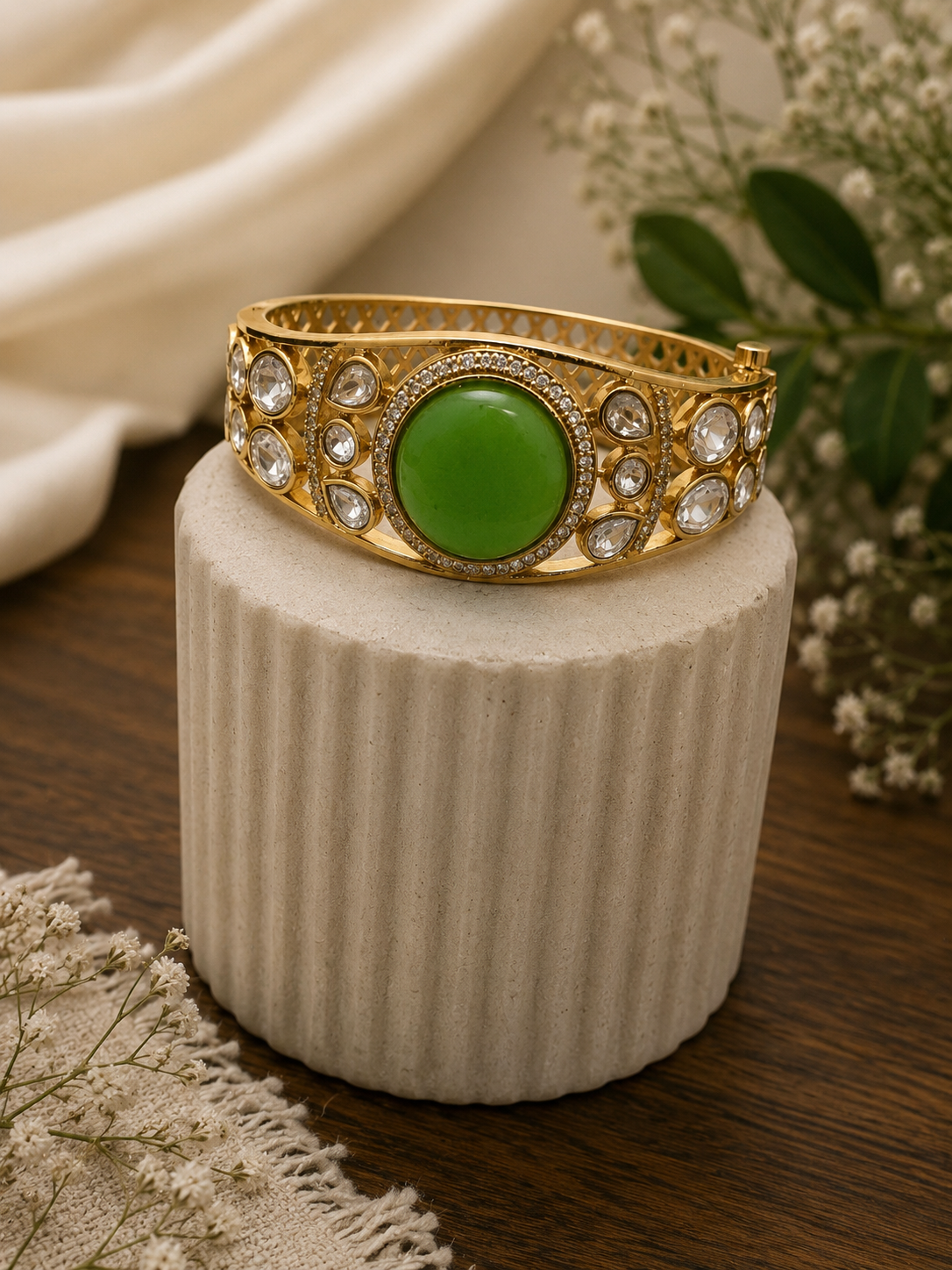 Vintage royal cuff bracelet in gold tone with round green center and crystal accents
