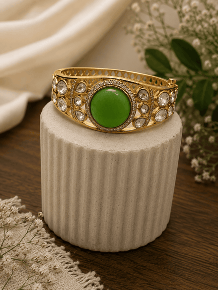 Vintage royal cuff bracelet in gold tone with round green center and crystal accents