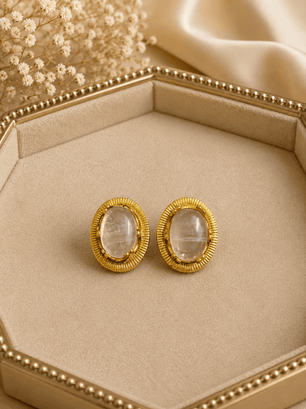 Oval white/clear stone stud earrings with gold-tone ridged bezel