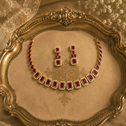 Gold-tone necklace with red and green stones and matching stud earrings