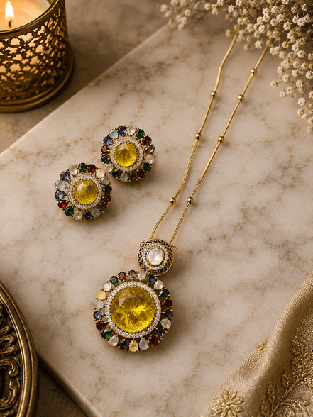 Gold-tone necklace and round stud earrings with yellow center stones and blue accents